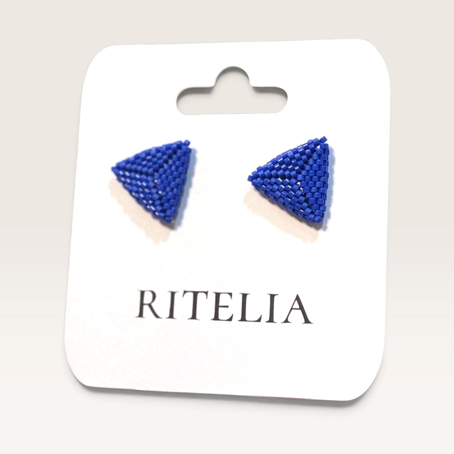 Ritelia handmade blue triangle earrings crafted with Japanese Miyuki beads on a display card