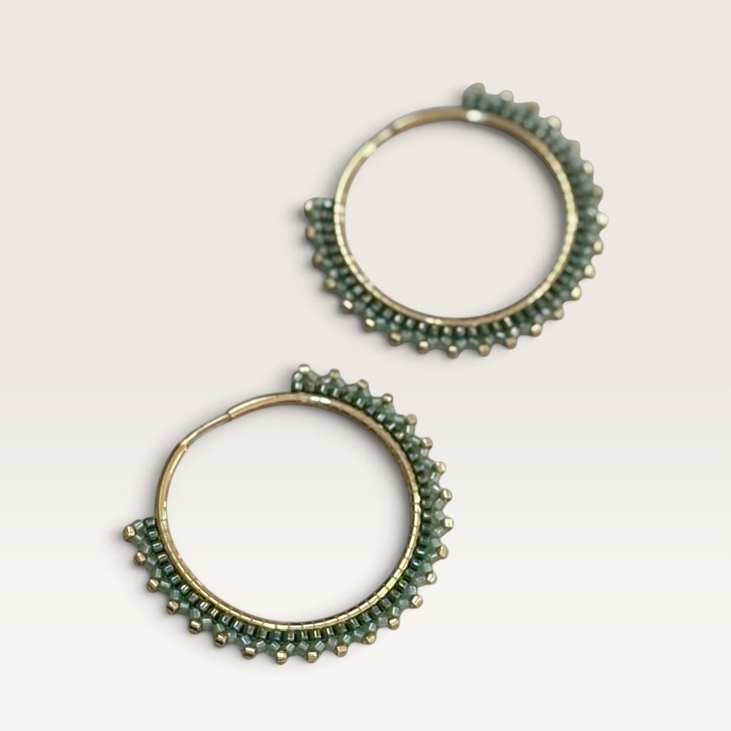 Ritelia Elena hoop earrings featuring sage and dark green Miyuki beads with gold accents on a 30mm gold-plated ring.