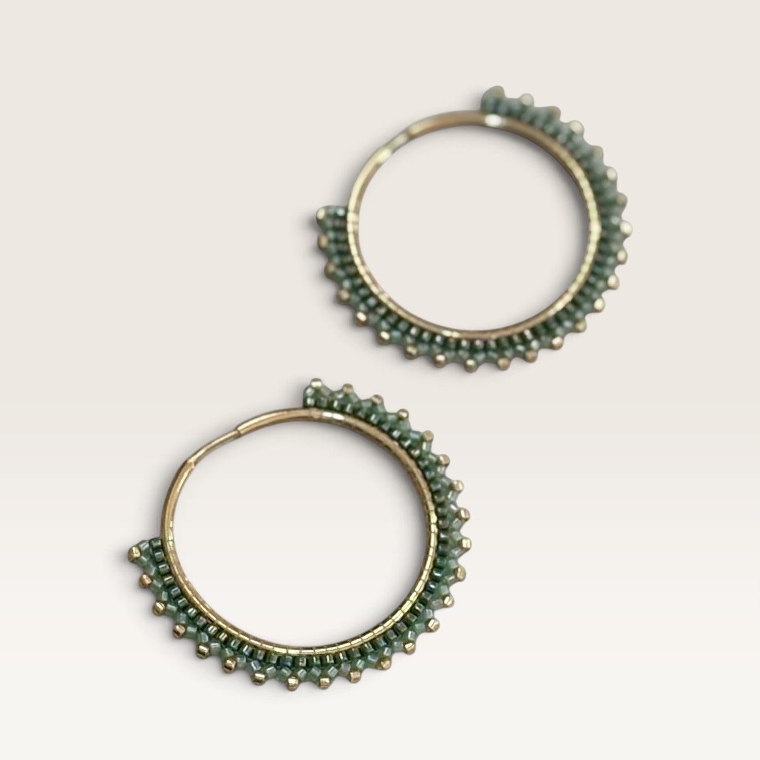 Ritelia Elena hoop earrings featuring sage and dark green Miyuki beads with gold accents on a 30mm gold-plated ring.