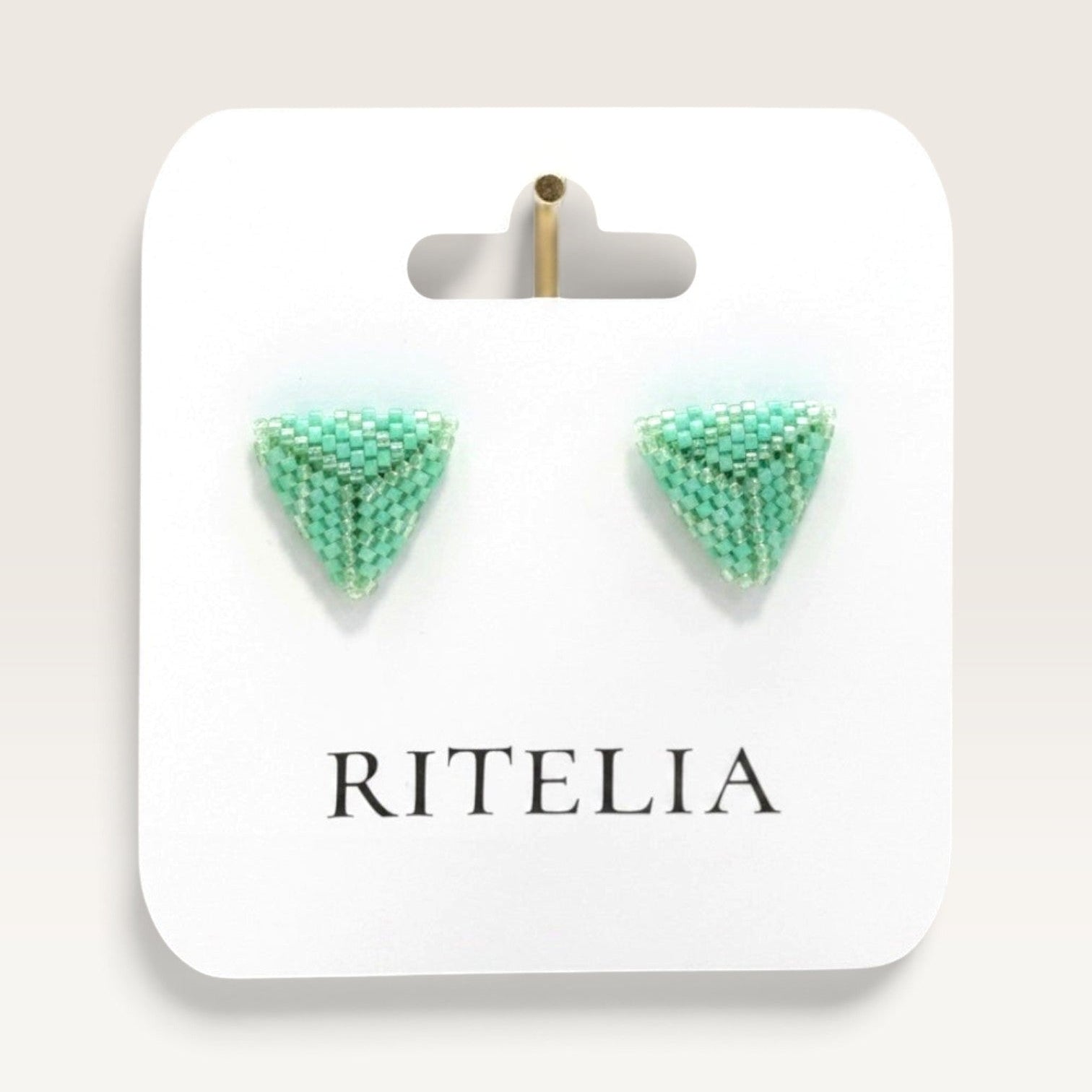 Ritelia handmade triangle stud earrings in jade green Miyuki Japanese beads on a branded display card.