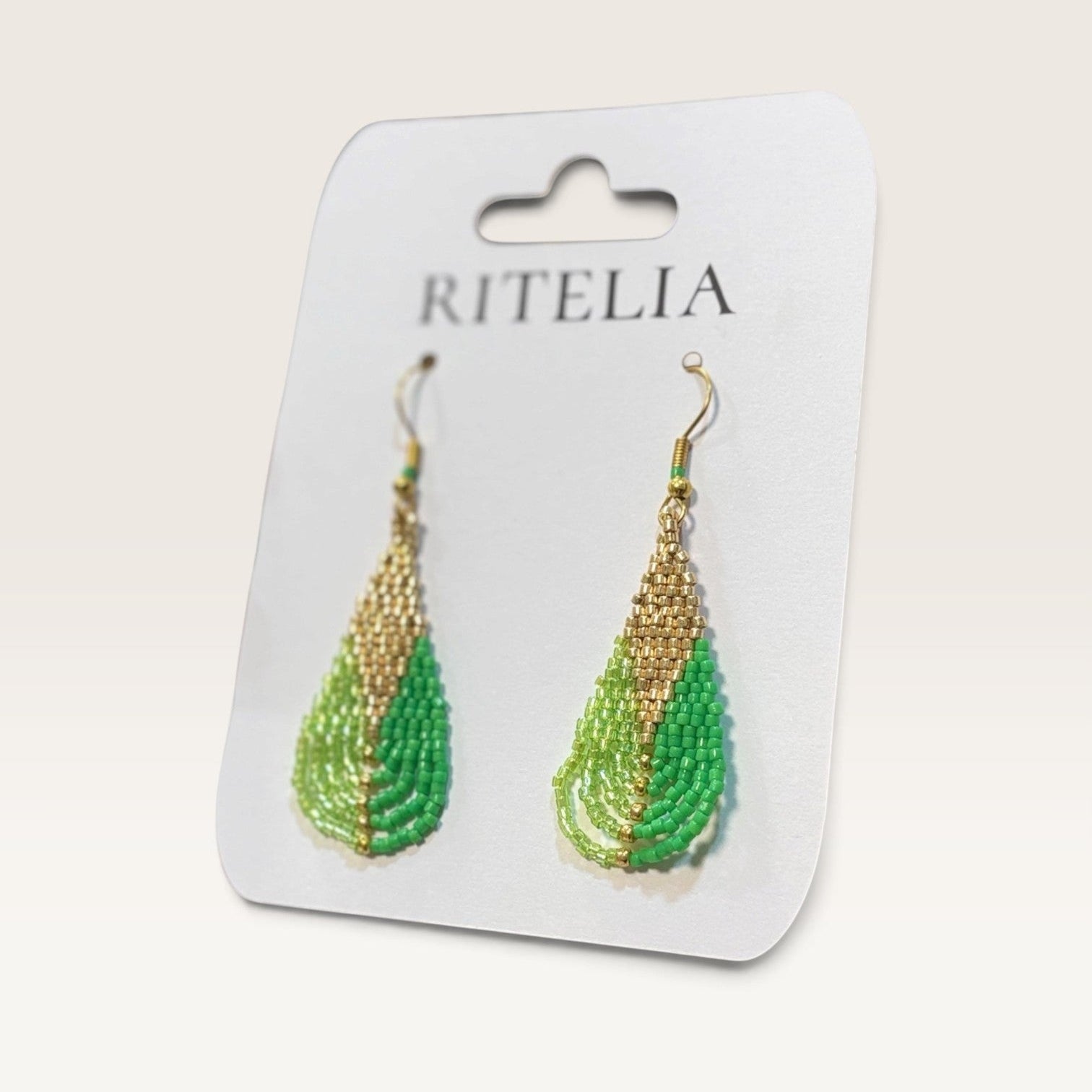 Ritelia Olivia handcrafted drop earrings with lime green, mint, and gold Miyuki beads on a display card.