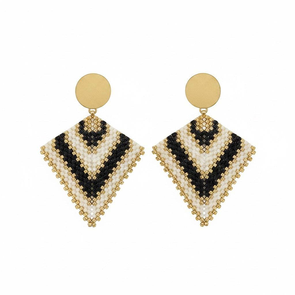 Ritelia Regina handmade drop earrings with black, cream, and gold Miyuki beads and a matte gold circular top.