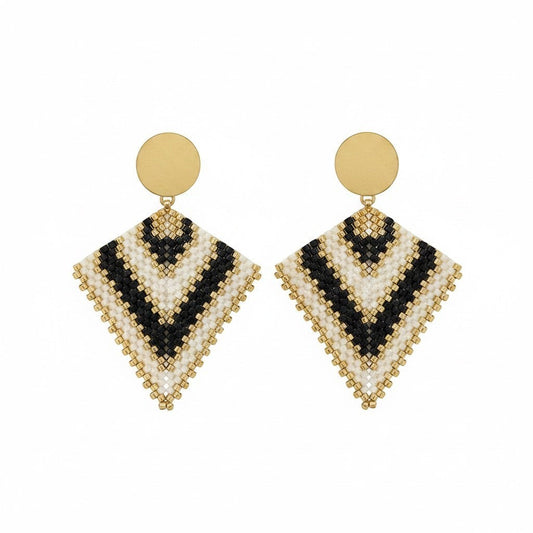Ritelia Regina handmade drop earrings with black, cream, and gold Miyuki beads and a matte gold circular top.